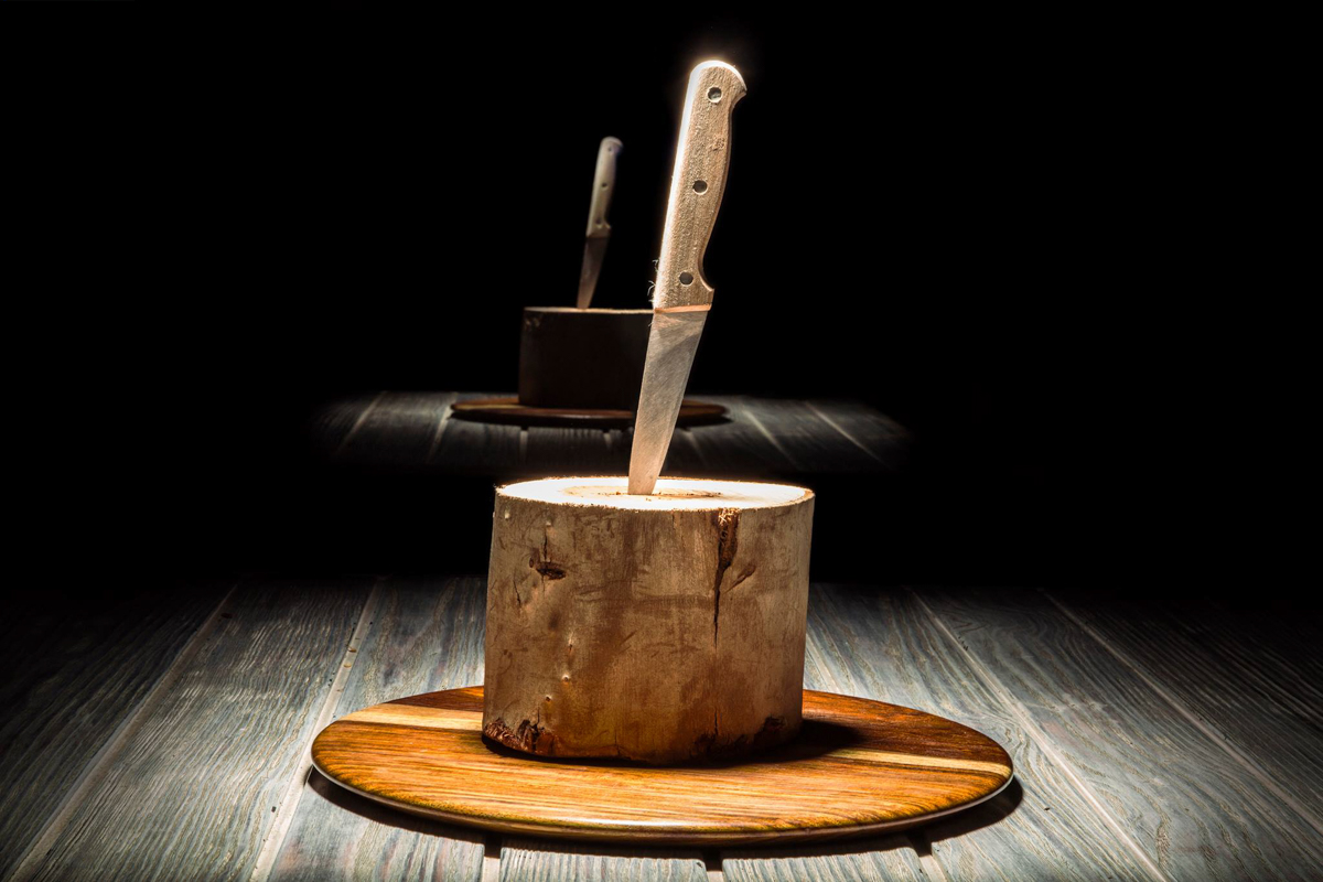 Frontage of Kazlak restaurant with three tables in front of him, and people are eating, talking and enjoying their time